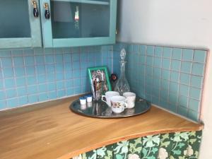 a tray with cups on a counter in a kitchen at Grand Circus Hotel in Malmö