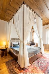 a bedroom with a canopy bed with curtains at Blu Macel Hotel & Suites -Old City Sultanahmet in Istanbul