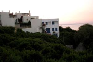 a white house on top of a hill at Emilianos Studio in Chios