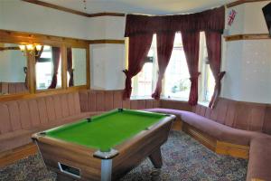 a room with a pool table and a couch and windows at Pine Lodge Hotel in Blackpool +33 photos