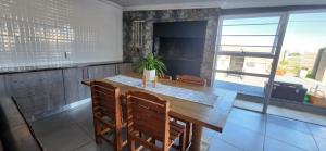 a kitchen with a large wooden table and chairs at 12 on Krisant avenue in Van Riebeekhoogte