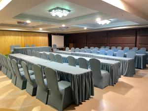 a conference room with rows of tables and chairs at Paradigm Sarovar Portico in Kākināda