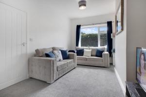 a living room with two couches and a window at Inviting 2-Bedroom Home in Coxhoe, Sleeps 4 in Coxhoe