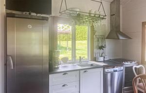 a kitchen with a stainless steel refrigerator and a sink at Cozy Home In Blankaholm With Wifi in Blankaholm