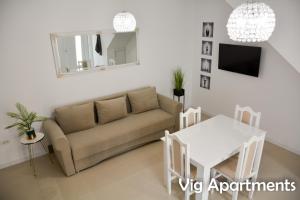 a living room with a couch and a table at Vig Apartments in Timişoara