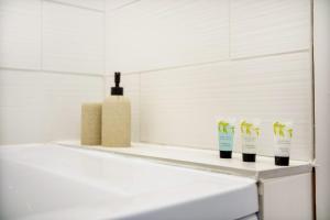 a shelf with threeambooambooambooials on top of a bathroom counter at Inviting 2-Bedroom Home in Coxhoe, Sleeps 4 in Coxhoe