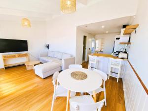 a living room with a white table and chairs at West Beach Lagoon 114 – Ocean Views in Perth