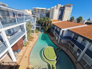 an aerial view of a swimming pool between two buildings at West Beach Lagoon 114 – Ocean Views in Perth