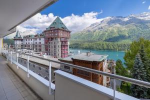 un gran edificio con vistas al lago y a las montañas en Au Reduit 106 en St. Moritz
