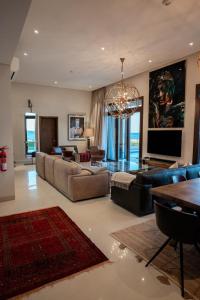 a large living room with couches and a chandelier at Night Moon Villa JEBEL SIFA ,BF-109 in Muscat