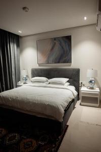 um quarto com uma cama grande e duas mesas de cabeceira em Night Moon Villa JEBEL SIFA ,BF-109 em Mascate