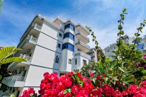 a building with flowers in front of it at Hotel Alpha in Sarandë