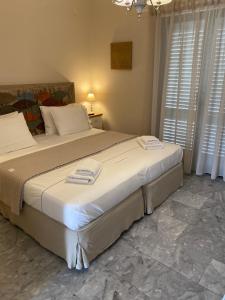 a bedroom with a large bed with towels on it at Aelia Houses in Agia Marina Aegina