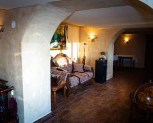 a living room with a couch and a table at Penzion Anička in Klokočov