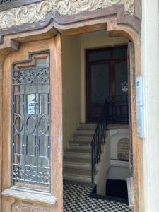 an entrance to a house with a glass door and stairs at Rustic Room next to beach in Constanţa