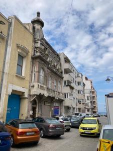 a group of cars parked in front of a building at Rustic Room next to beach in Constanţa