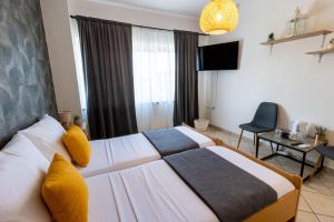 a hotel room with a bed and a television at DELUXE ROOMS BURE in Murter