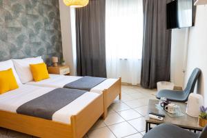 a hotel room with a bed and a table and a chair at DELUXE ROOMS BURE in Murter