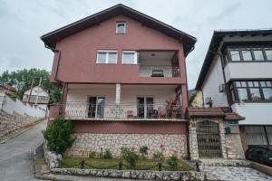 a house with a balcony on the side of it at Apartment Bistrik medresa in Sarajevo