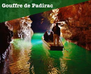 a man riding a boat under a bridge in a cave at Gambetta 403 CahorsCityStay in Cahors