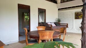 a wooden table and chairs on a patio at Private 2 bedrooms in Munduk
