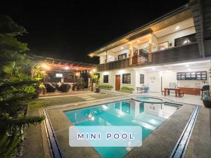 a villa with a swimming pool at night at Cevy's Place at Liliw, Laguna in Liliw