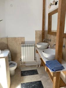 a bathroom with a sink and a toilet and a mirror at Rustic room 2 next to beach in Constanţa