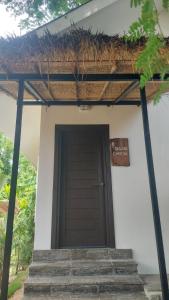 a entrance to a house with a brown door at Cheeva at pai ชีวา แอท ปาย in Pai