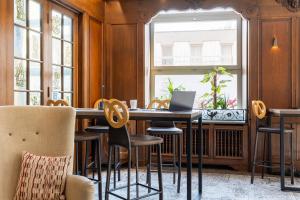a dining room with a table with chairs and a laptop at Best Western Plus Monopole M&eacute;tropole in Strasbourg