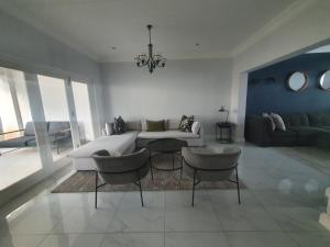 a living room with a couch and a table and chairs at Royal Manor in Johannesburg