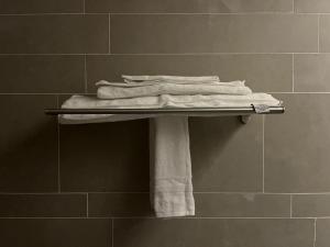 a pile of towels on a towel rack in a bathroom at Paradise of North Riyadh جنة شمال الرياض in Riyadh +69 photos