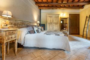 a bedroom with a large bed and a table at Cascina Veja in Chiusa di Pesio