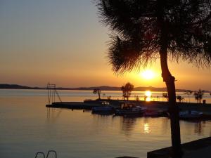 a sunset over a marina with boats in the water at Hollywood rooms in Sveti Petar +71 photos