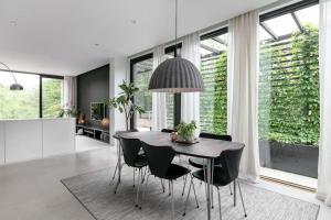 uma sala de jantar com uma mesa e cadeiras pretas em Swedish Elegance & Luxury Home em Estocolmo