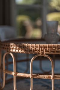 a wicker coffee table with a table in the background at Apartment Søglas in Gmund am Tegernsee