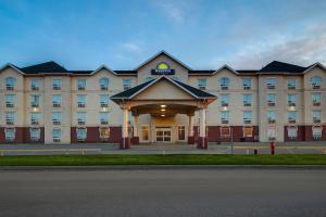 a large building with a gazebo in front of it at Days Inn by Wyndham Dawson Creek in Dawson Creek