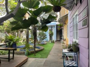 a walkway with palm trees and plants in a building at Zan HomeStay in Buon Ma Thuot