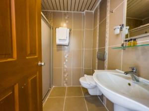 a bathroom with a sink and a toilet at Dedeoğlu Port Hotel in Fethiye