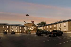 a parking lot with trucks parked in front of a building at SureStay Plus Hotel by Best Western Elizabethtown Hershey in Elizabethtown