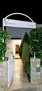 a white gate in a building with a fence at Apartments Vesna in Pinezici