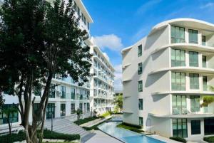 an apartment building with a pool in front of it at Wyndham La Vita Rawai Phuket in Rawai Beach
