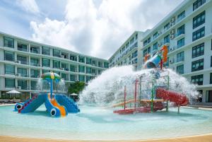 a water park with a water slide in a building at Wyndham La Vita Rawai Phuket in Rawai Beach