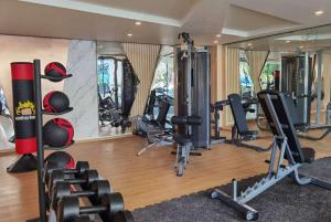 a gym with several treadmills and exercise bikes at Wyndham La Vita Rawai Phuket in Rawai Beach