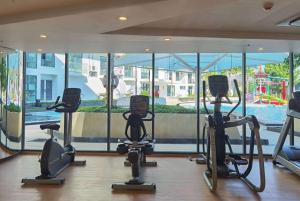 a gym with cardio equipment in front of a large window at Wyndham La Vita Rawai Phuket in Rawai Beach