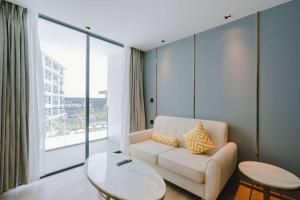 a living room with a couch and a large window at Wyndham La Vita Rawai Phuket in Rawai Beach