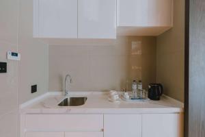 a kitchen with a sink and a counter top at Wyndham La Vita Rawai Phuket in Rawai Beach