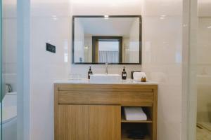 a bathroom with a sink and a mirror at Wyndham La Vita Rawai Phuket in Rawai Beach