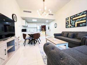 a living room with a couch and a table at Marina Wharf II Dubai Marina - AL Maraseem in Dubai