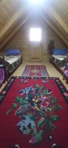 a room with a rug on the floor in a attic at Velemun brvnara in Plav