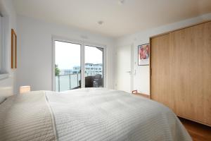 a bedroom with a large bed and a large window at Seaside in Laboe